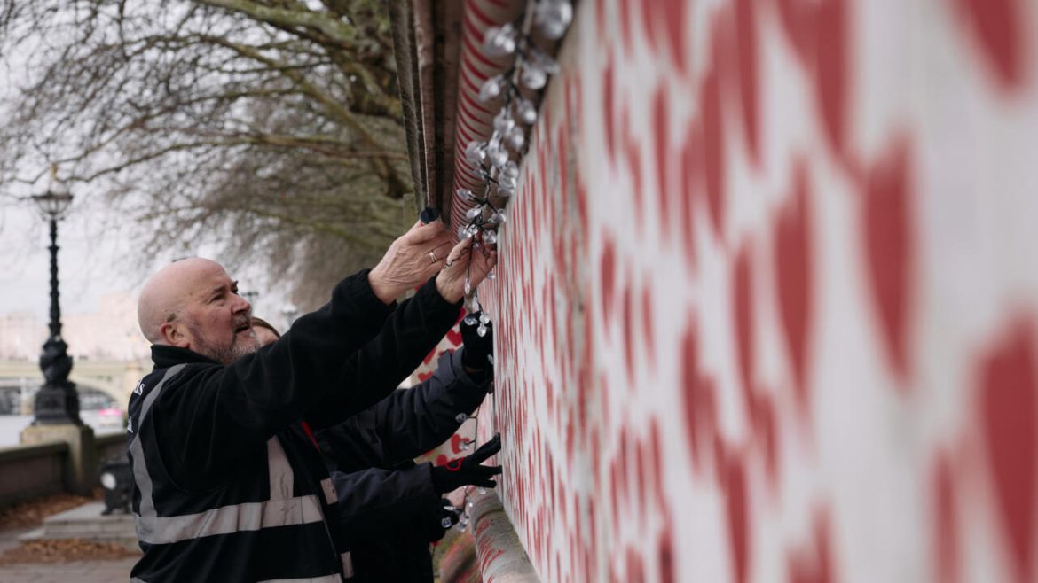 London wall illuminates Covid's enduring pain at Christmas